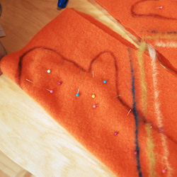 Pin the halves of the mittens together.